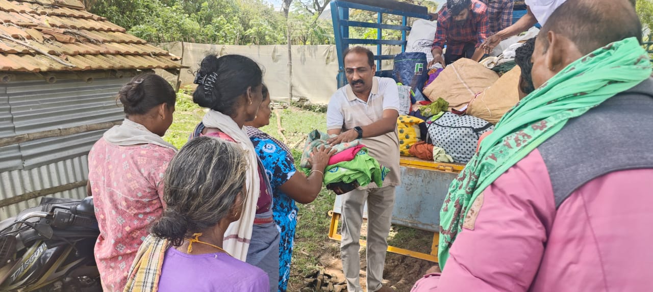 Collected clothes handed over from the truck to families